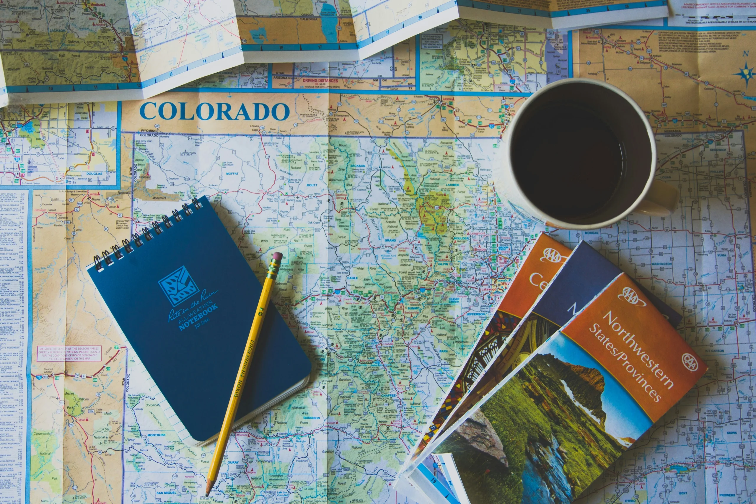 Travel planning with maps, brochures and coffee – airport transfer Vienna